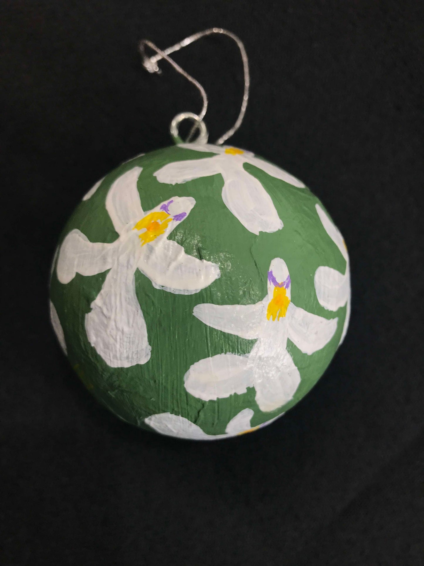 Hand-painted green Christmas bauble with a floral pattern featuring white and purple orchids.