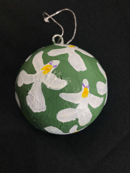 Hand-painted green Christmas bauble with a floral pattern featuring white and purple orchids.