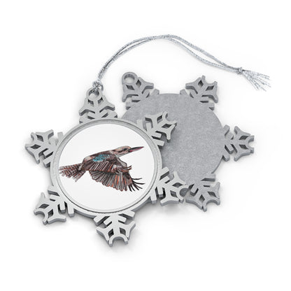 A pewter snowflake ornament with a unique design featuring an animal in the center, connected to a silver-toned hanging string.